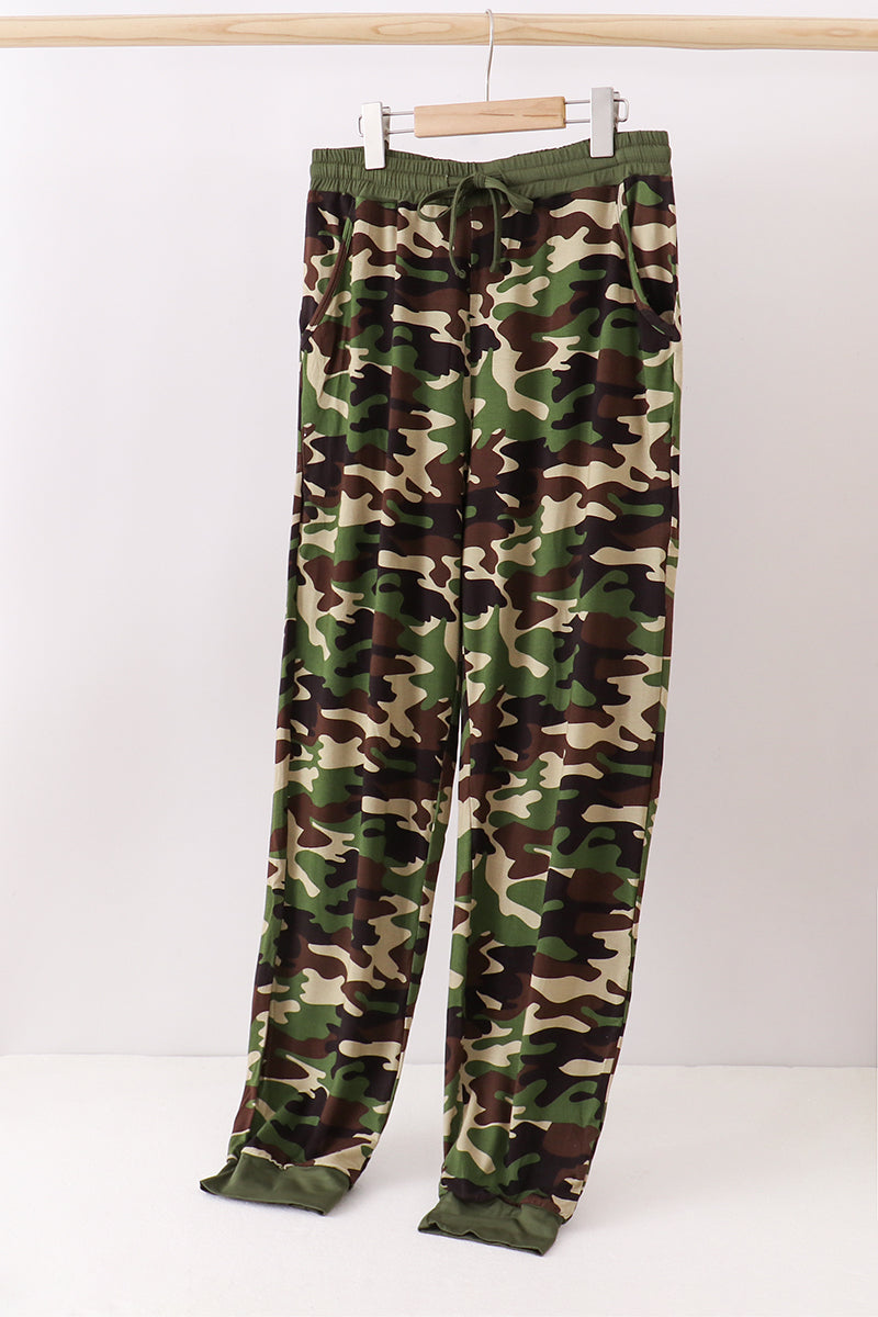 Camouflage pants on a hanger against a white background